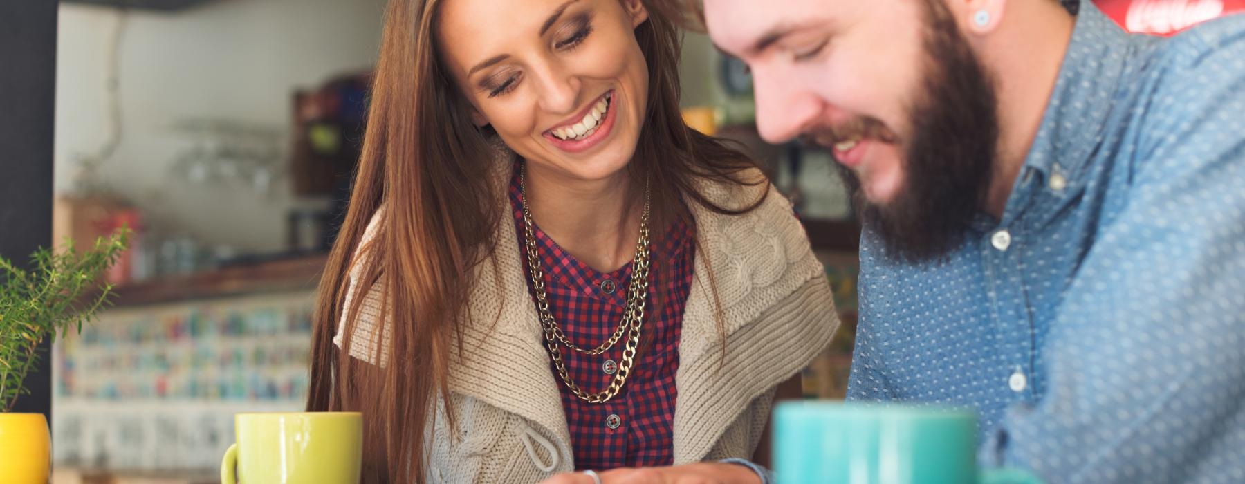 a man and a woman looking at a laptop