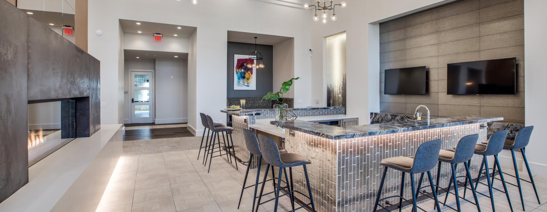 a kitchen with a bar and chairs